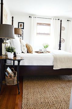 a bedroom with white bedding and pillows