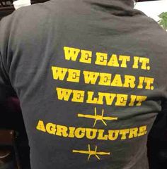 the back of a man's shirt that says we eat it, we wear it, we live it, agriculture