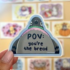 a hand holding up a sticker that says pov you're the bread