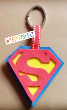 a keychain with a superman symbol on it and a tag attached to it