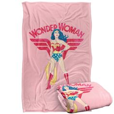 a pink blanket with wonder woman on it and an image of the dc comics character