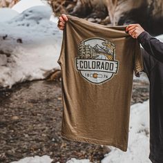 Combining organic outdoor vibes with ColoradoCool's bold style, this Colorado t-shirt is a great blend of organic outdoor colors, sweet outdoor Colorado landscape while sporting "COLORADO" nice and loud. The smaller design on the front is perfect for those who like to put into practice a little bit of that "mullet approach", business in the front and party in the back. Snag this sweet Colorado t-shirt and you'll find yourself feeling like a true mountaineer...with mad style. Colorado gear with a Outdoor Vibes, Co Company, Sport T Shirts, Colorado Outfits, Colorado Landscape, Colorado Flag, State Of Colorado, Sustainable Manufacturing, Bold Style