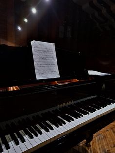 a black piano with sheet music on it