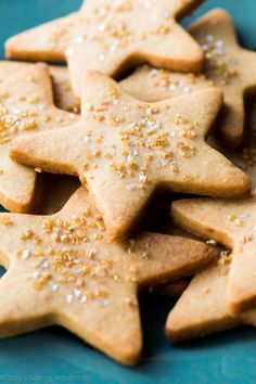 some cookies are on a blue plate with sprinkles and gold flakes