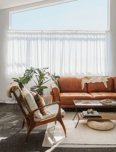 a living room with two couches and a coffee table in front of a large window