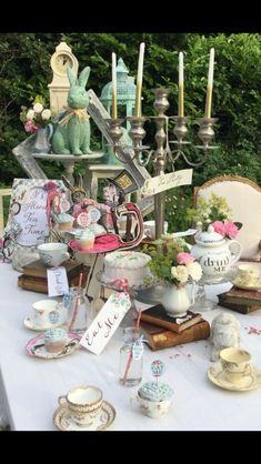 a table topped with lots of tea cups and saucers