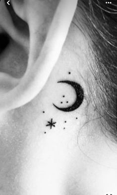 a woman's behind the ear has a small crescent and stars on it