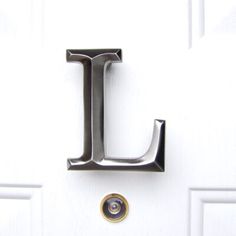 the letter l is attached to a white door