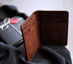 The Laodikya vertical bifold leather wallet takes on the timeless wallet style.  The attention to detail and minimalist design of the Laodikya wallet will elevate your everyday style and turn heads everywhere you go. Every hide is unique and carries its character. Because of the nature of leather, there may be several blemishes on the leather, as seen in the photos. Artisan Gift, Wallet Organization, Leather Pieces, Engraved Items, Wallet Fashion, Mens Green, Mens Jewelry Bracelet, Practical Gifts, Heart Jewelry