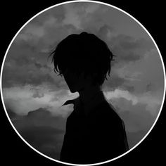 the silhouette of a person standing in front of a dark sky with clouds behind them