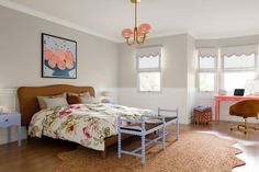 a bedroom with white walls and wooden floors