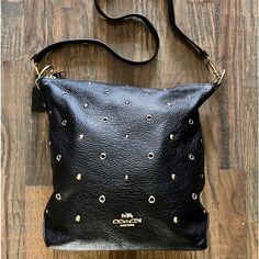 Coach Abby Duffle Black Crossbody Handbag; Black Pebbled Leather, Zipper Closure, Gold And Silver Accent Studs, Back Zipper Pocket, Interior Zipper Pocket, Detachable Adjustable Strap. Slight Wear On Ring Hardware (See Photo), No Scuff Or Rips O Leather Or Interior. Gently Used Handle Drop: 7.75” Strap Drop: 20.5” L: 9.75” H:12” W: 4” Coach Crossbody Hobo Bag With Zipper Closure, Coach Black Shoulder Bag With Snap Closure, Black Coach Shoulder Bag With Snap Closure, Chic Coach Shoulder Bag With Snap Closure, Coach Shoulder Bag With Snap Closure, Bags Coach, Black Pebbles, Handbag Black, Black Crossbody