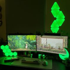 two computer monitors sitting next to each other on top of a desk with green lights