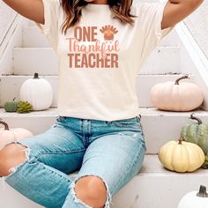 Thankful Thanksgiving Teacher T-shirt. Great for Gifts and Parties. Perfect for Thanksgiving dinner, teachers and homeschool teachers. This classic unisex jersey short sleeve tee fits like a well-loved favorite. Soft cotton and quality print make users fall in love with it over and over again. These t-shirts have-ribbed knit collars to bolster shaping. The shoulders have taping for better fit over time. Dual side seams hold the garment's shape for longer. \n.: 100% Airlume combed and ringspun co Teacher Thanksgiving Shirts, Relaxed Fit School Spirit T-shirt For Fall, White T-shirt For School In Fall, Relaxed Fit T-shirt For School In Fall, Casual White T-shirt For Teacher Appreciation, White Graphic Tee For Teaching, White Cotton T-shirt For Teaching, White Pre-shrunk T-shirt, White Cotton T-shirt