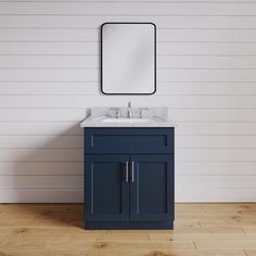 a bathroom vanity with a mirror above it and a sink below the cabinet in blue