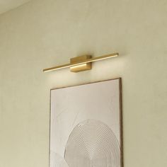 a painting hanging on the wall next to a lamp