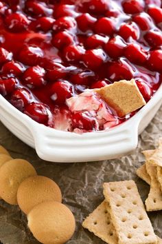 cherry cheese dip with crackers on the side in a white casserole dish