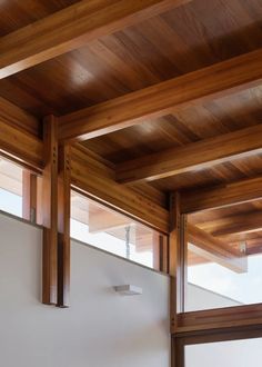 an empty room with wooden beams and white walls