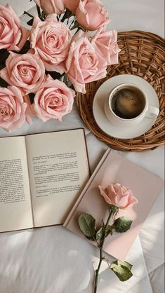 an open book with pink roses and a cup of coffee