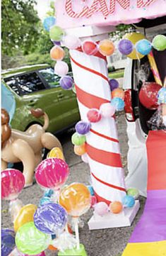 a candy bar with balloons and candies on the ground