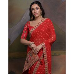 Red colored saree is made from georgette fabric which is highlighted with beautiful bandhej printed work as shown. Comes along with unstitched mono silk blouse piece which you can customise as per your design/style. Occasion - You can wear this saree for party, functions and fashionista. Note:- the actual product may differ slightly in color and design from the one illustrated in the images when compared with computer or mobile screen. Measurements: Saree : Georgette : 5.5 Mtrs Blouse : Georgett Festival Georgette Pre-draped Saree With Printed Border, Bandhani Print Pre-draped Saree For Puja, Red Saree With Bandhani Print, Red Bandhani Print Unstitched Saree, Red Bandhani Print Pre-draped Saree In Art Silk, Festive Bandhani Print Georgette Choli, Red Bandhani Print Saree For Diwali, Bollywood Style Red Pre-draped Saree With Printed Border, Transitional Red Georgette Blouse Piece