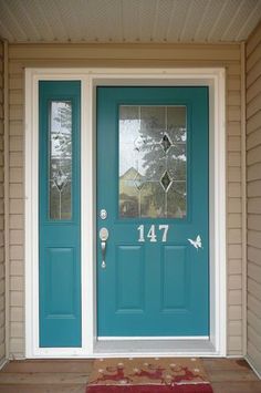 a blue front door with the number forty seven on it