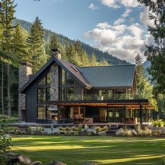 a large house in the middle of a lush green field with rocks and trees around it