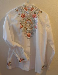 Vintage Lady's blouse, beautifully hand embroidered in floral pattern on the front bodice, the collar, the sleeves and the side slits; the collar and cuffs have a beautiful embroidered scalloped detail. It is hand embroidered and made in China; labeled size is medium: bust is 36", 18 1/2 from armpit to armpit); sleeve length is 22" shoulder to wrist, length is 24" shoulder to hem. It's 78 % polyester and 22% cotton; snap enclosures are topped by fancy coiled ribbon buttons. Luxury Embroidered Tops With Mandarin Collar, Label Sizes, Ladies Blouse, Amalfi, Collar And Cuff, Womens Clothing Tops, Hand Embroidered, Labour Day, Vintage Ladies