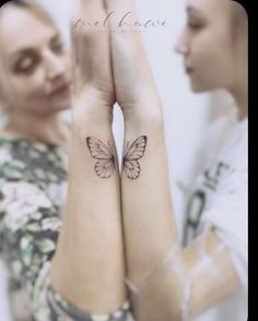 two people with tattoos on their arms and one has a butterfly tattooed on the wrist