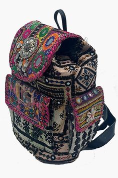 Unleash your bohemian spirit with this stunning Banjara backpack. Adorned with intricate mirror work, vibrant patchwork, and authentic shells, this handcrafted piece is a true celebration of Indian artistry. The combination of soft leather accents and durable construction ensures both style and longevity. Carry your world with flair and embrace the magic of handmade craftsmanship. Disclaimer: These are 100% handmade bags. No 2 bags are the same. Guaranteed that you will receive the same bag but Traditional Multicolor Backpack For Travel, Traditional Multicolor Rectangular Backpack, Bohemian Multicolor Backpack For Festival, Multicolor Rectangular Backpack For Festivals, Handmade Bohemian Rectangular Backpack, Bohemian Backpack For Festivals, Multicolor Rectangular Festival Backpack, Festival Rectangular Multicolor Backpack, Bohemian Style Handmade Multicolor Backpack