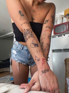 a woman with tattoos on her arms and arm