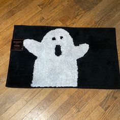 a bathroom rug with a ghost on it