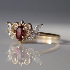 An upgraded version of the round cut ring of wisdom, this ring features a gorgeous 0.75 carat round cut pink sapphire. Red Crown Jewelry For Wedding, Heirloom Garnet Birthstone Ring For Wedding, Daily Rings, Jewelery Ring, Whimsical Ornaments, Whimsical Ring, Ruby Wedding Band, Sailor Moon Anime, Queen Rings