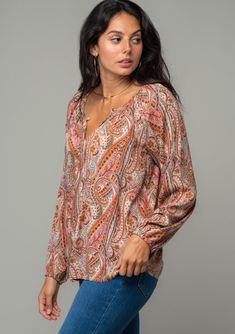 A classic bohemian blouse in an orange paisley print. FINAL SALE Paisley print Relaxed, flowy fit Voluminous long raglan sleeve Elastic wrist cuff Front keyhole with button-loop closure Flowy bohemian peasant top This classic peasant blouse is designed in a vintage-inspired paisley print. With voluminous long raglan sleeves, a front keyhole with optional button loop closure, and a flattering flowy fit. We love to pair this effortless style with our favorite vintage denim. Model is 5'8, wearing a Bohemian Blouse, Multi Color Blouse, Bohemian Blouses, Peasant Top, Peasant Blouse, Peasant Tops, Fall Wardrobe, Boho Tops, Vintage Denim