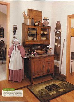 an old fashioned kitchen with wood floors and cabinets in the corner, including a rug