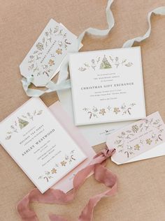 the wedding stationery is laid out with ribbon