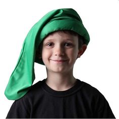 a young boy with a green hat on his head