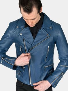 The Defector blue leather jacket combines old-school style with stand-out features, notably a forearm zipper, polished nickel ball pull zippers, side straps, and a curved hem. The body features quilted lining and the sleeves are non-quilted. Fitted, premium leather relaxes and conforms to your shape and breaks in perfectly. ✦ Slim fit. Size up for a relaxed fit, additional room, or layering.✦ Premium full-grain buffalo napa leather is 1 – 2 mm thick. Leather and fit for style and function. ✦ Leather quickly conforms to your shape and breaks in within one season.✦ Ideal leather for motorcycle riding and is built to last.✦ Removable STH engraved metal church key hangs from inside pocket.✦ Double-stitched seams in interior lining for additional reinforcement.✦ Durable YKK zippers.✦ One STH en Blue Biker Jacket With Zipper Closure, Classic Blue Long Sleeve Leather Jacket, Blue Moto Biker Jacket With Zipper Closure, Blue Leather Outerwear For Streetwear, Blue Leather Streetwear Outerwear, Fitted Blue Biker Jacket With Zipper Closure, Blue Moto Biker Jacket For Streetwear, Blue Long Sleeve Biker Leather Jacket, Blue Fitted Moto Leather Jacket