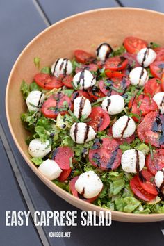 a salad with mozzarella and tomatoes in a bowl