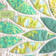 a close up view of a quilt with the words talk town on it