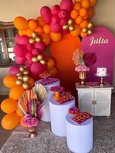 there are many balloons and decorations on the wall in this party decoration set up for an event