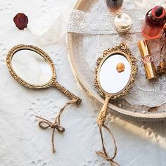 two magnifying glasses sitting on top of a table next to bottles and other items