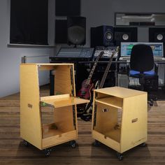 there are two speakers in the room and one is on top of a shelf with a guitar