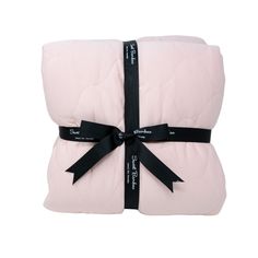 the pink blanket is wrapped in black ribbon