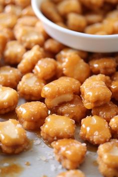 some kind of food that is sitting on a table next to a small white bowl