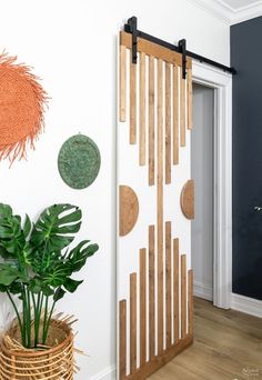 a room with some plants and decorations on the wall