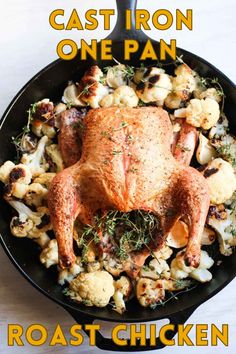 the cast iron one pan roast chicken in a skillet with roasted cauliflower