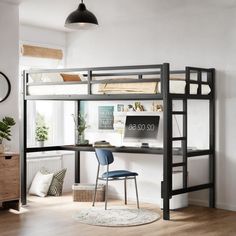 a loft bed with a desk underneath it in a room that has hardwood floors and white walls