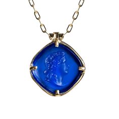 Channel the divine energy of Apollo, the ancient Greek god of the sun, music, and prophecy, with the Apollo Blue Pendant Necklace. This captivating pendant features a finely sculpted bust of Apollo carved into a rich blue chalcedony stone, known for its calming and protective properties. Set against a luxurious 18ct gold chain, this piece exudes both elegance and symbolism, offering a perfect blend of timeless beauty and deeper meaning.  The serene hue of the blue chalcedony symbolises peace, emotional balance, and communication. With Apollo, as the god of light and wisdom, representing clarity, creativity, and inspiration. Wearing this pendant serves as a reminder of your own inner light and the power of knowledge, harmony, and self-expression. 18k Gold Plated 925 Sterling Silver/Blue Cha God Of Light, God Of The Sun, Power Of Knowledge, Golden Horn, Blue Pendant Necklace, Sun Music, Divine Energy, Deeper Meaning, Horn Jewelry