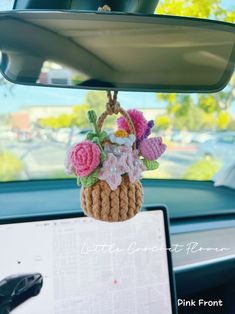 a car dashboard with a flower basket hanging from the dash board